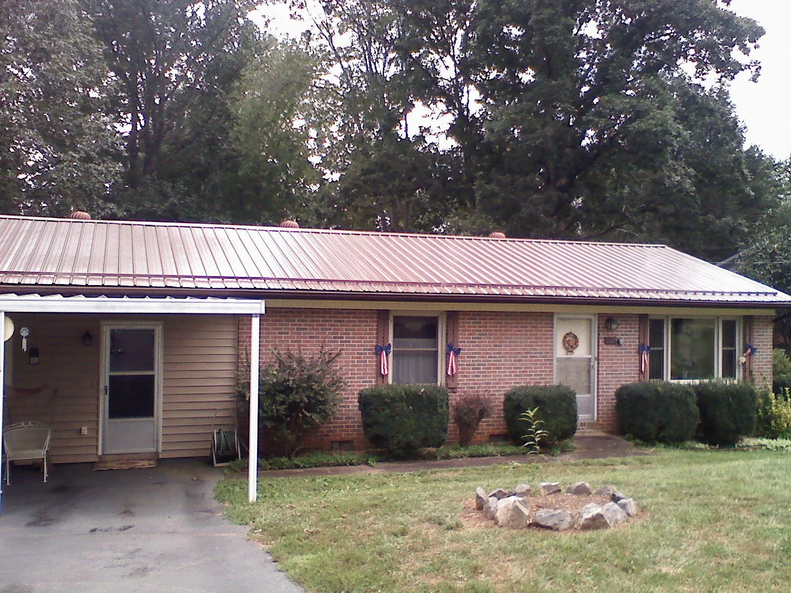 Bronze metal roof and carport on a brick ranch home — Roof Repair work by our crew in Long Beach